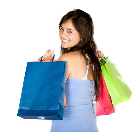 beautiful teenager with shopping bags over white with a big smile