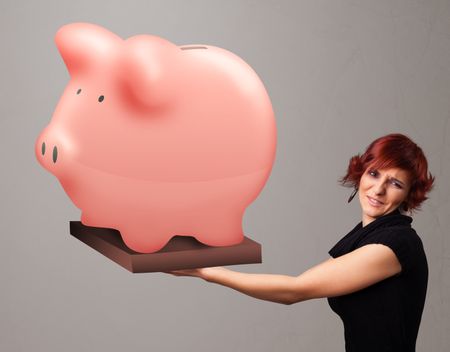 Beautiful young girl holding a huge savings piggy bank