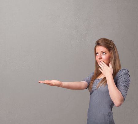 Pretty young woman presenting an empty copy space