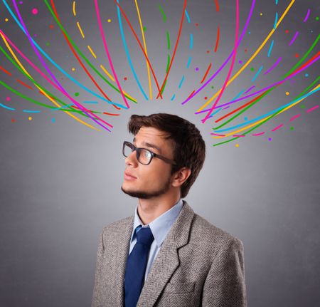 Young man standing and thinking wiht colorful abstract lines overhead