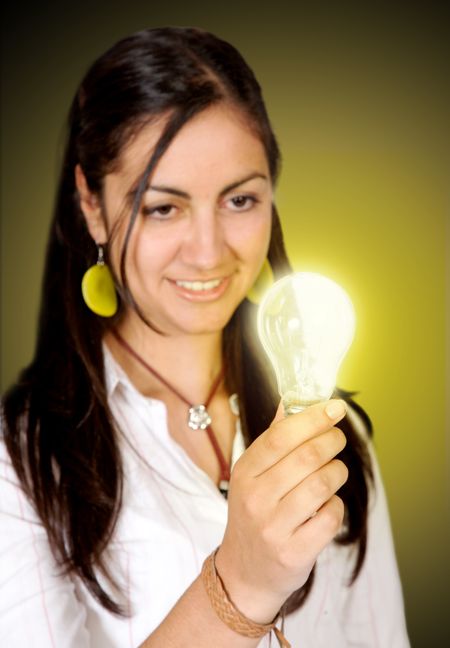 young woman staring at a light bulb - concept of idea
