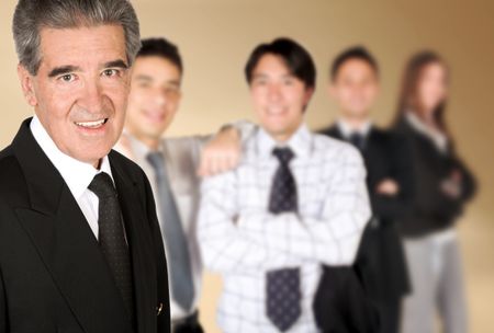friendly business man smiling with his colleagues blurred in the background
