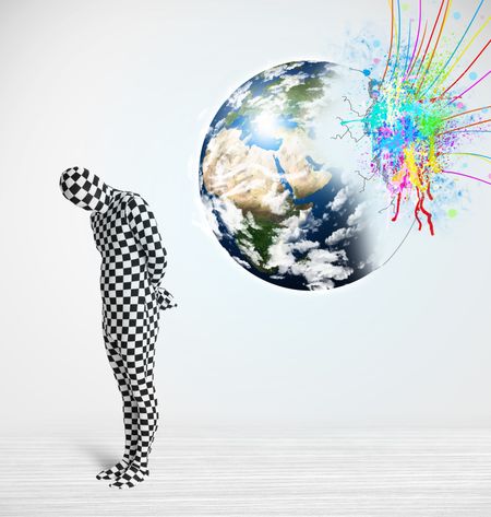 Funny man in body suit looking at colorful splatter 3d earth, Elements of this image furnished by NASA