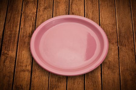 Colorful empty shiny plate on grungy background table 