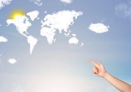Young hand pointing at world clouds and sun on blue sky