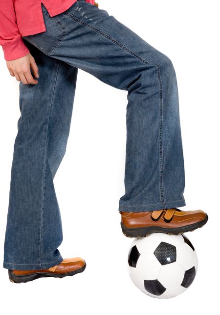 casual guy stepping onto a soccer ball over white