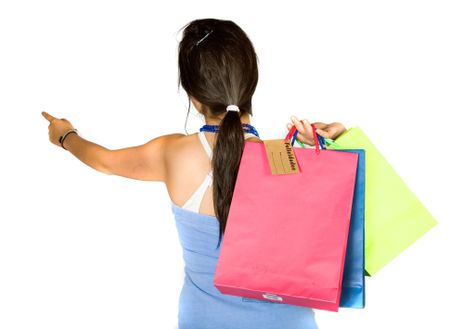 beautiful teenager with shopping bags over white