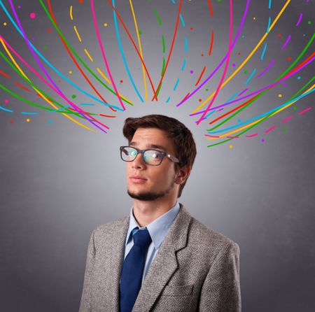 Young man standing and thinking wiht colorful abstract lines overhead