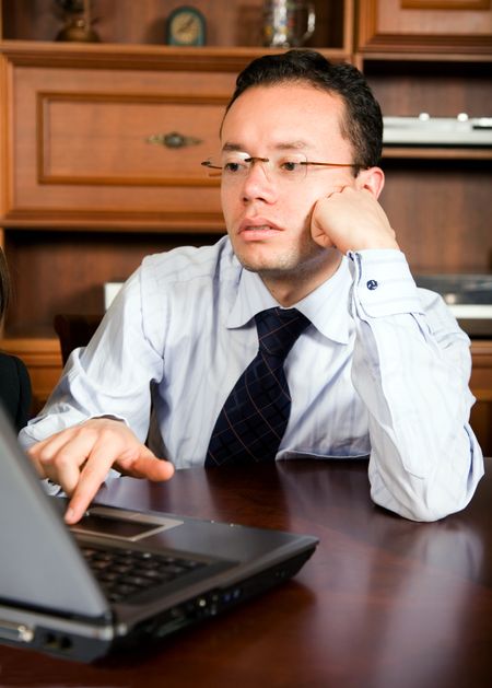 business man in his office on a laptop computer - focus is on his face