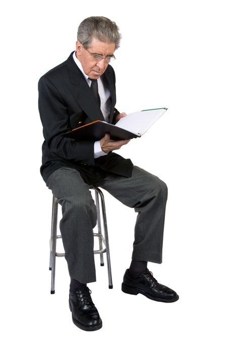 business man reading a book on a stool over white background