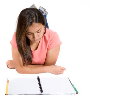 girl reading a notebook on the floor over white background