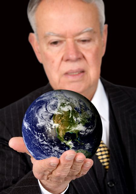 business man holding a globe over a black background - globe is from http://www.nasa.gov