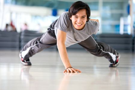 man at the gym doing stretching exercise