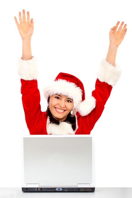 christmas girl happy with her success while working on a laptop - isolated over a white background