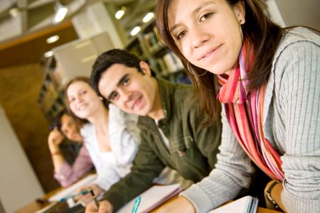 college or university students at the library studying