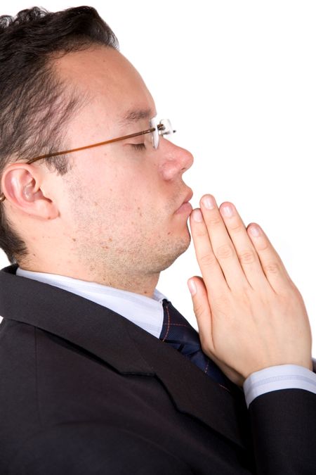 business man with eyes closed doing a prayer over a white background