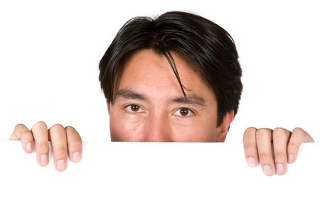 latin american man peeping over white card over a white background