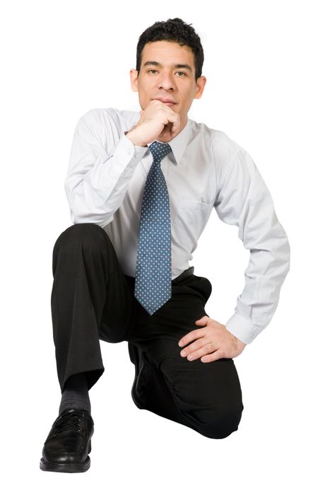 confident business man kneeling on the floor over white