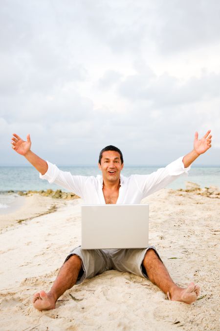 successful business man on holiday using his laptop