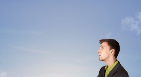 Handsome man looking at the blue sky copyspace concept