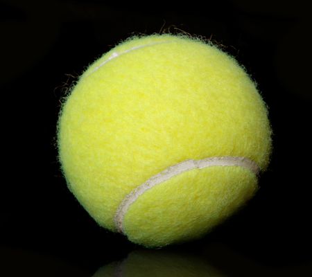tennis ball over a black background with reflection