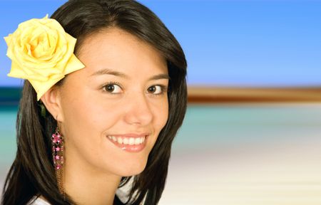 beautiful girl portrait on a beach with a flower on her head
