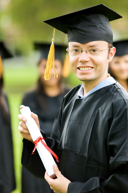 graduation man portrait smiling and looking happy outdoors