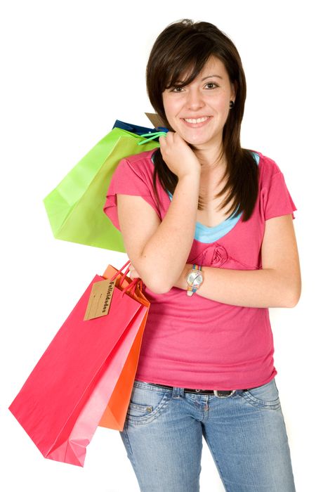 beautiful teenager with shopping bags over white