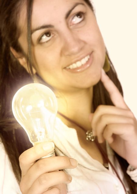 business woman holding a lightbulb (shallow DOF, focus on light bulb)