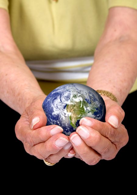 hands of an eldery woman holding an earth globe - globe is from http://www.nasa.gov