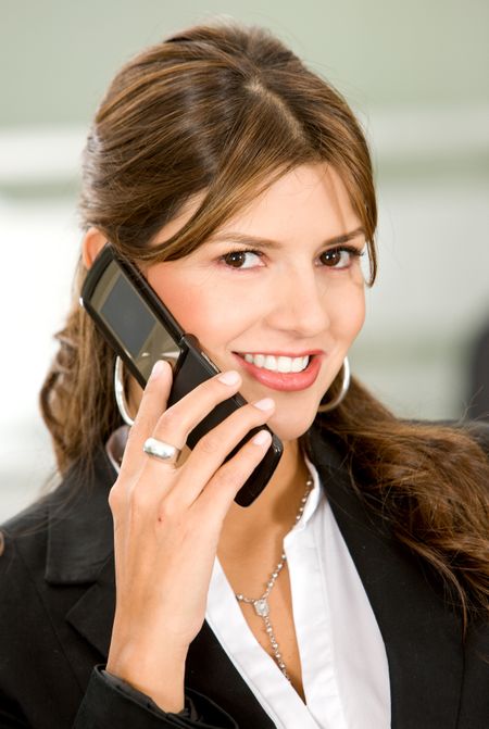 business woman on the phone smiling at the office