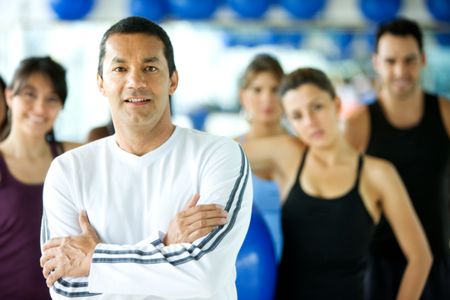group of people at the gym with the trainer leading