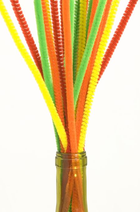 Bouquet of pipe cleaners in neck of wine bottle