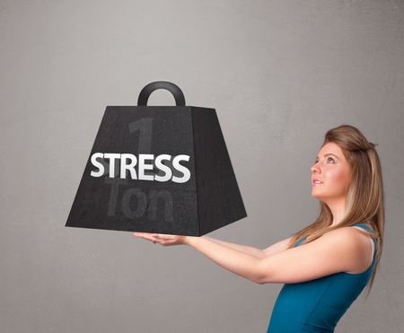 Attractive young woman holding one ton of stress weight