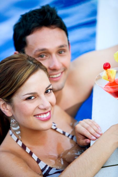 couple having a drink while on vacation smiling