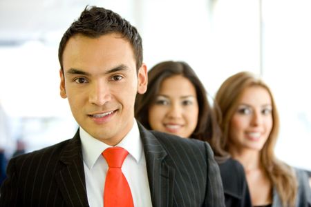 business people in an office smiling - small team