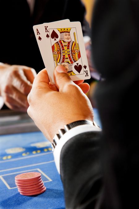 man playing blackjack in a casino - good hand