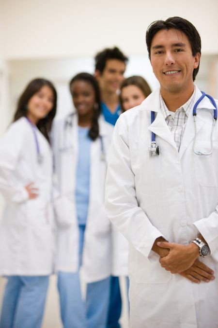 male doctor leading a group of doctors in a hospital