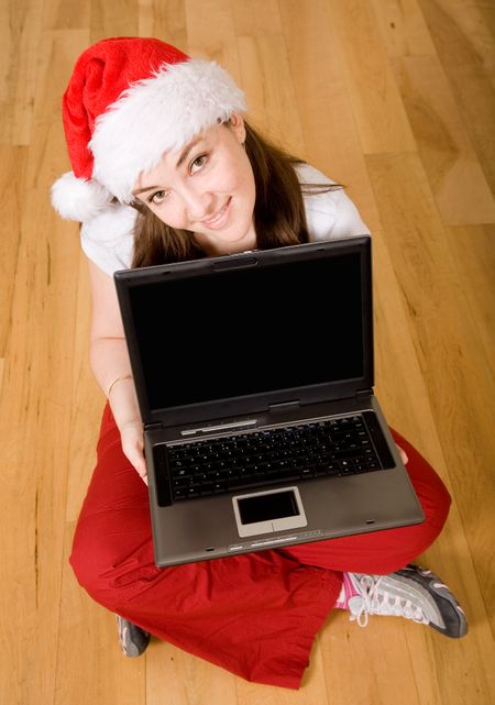christmas online shopping - female santa with a laptop