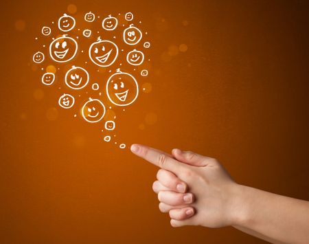 Group of happy hand drawed smiley faces coming out of gun shaped hands