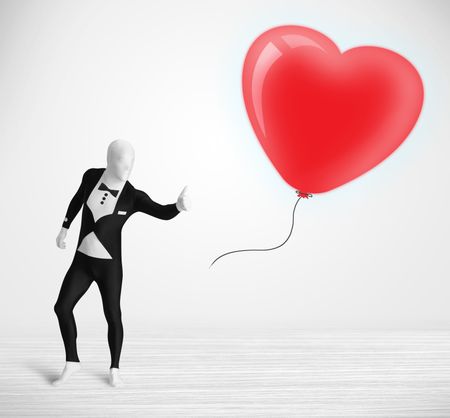 Cute guy in morpsuit body suit looking at a red balloon shaped heart