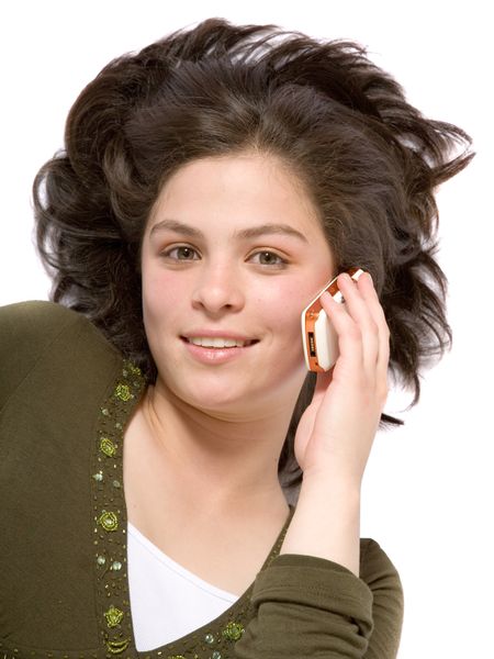 beautiful girl talking on the phone on the floor over white