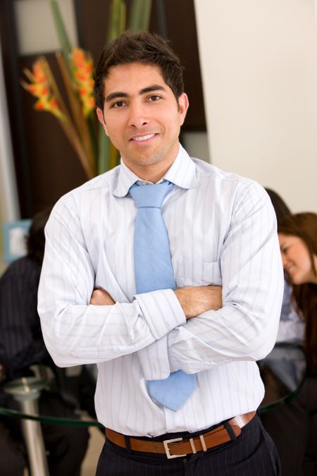business man portrait in an office smiling
