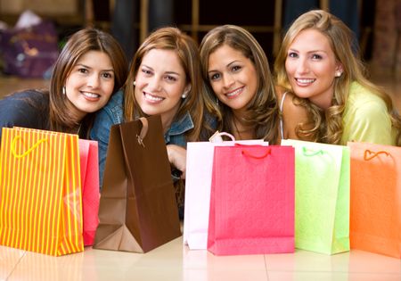 casual girls with shopping bags in a store smiling