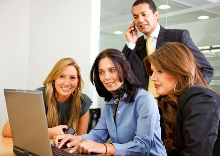 business team in an office meeting on a laptop computer