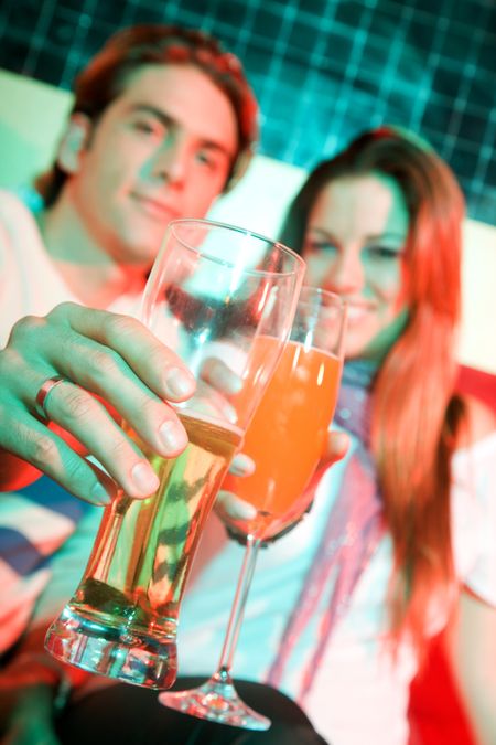 couple in a bar having a drink and smiling