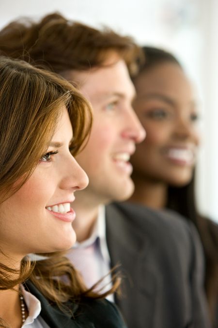 business people smiling in an office looking away