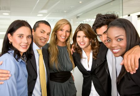 group of business people in an office smiling - small team