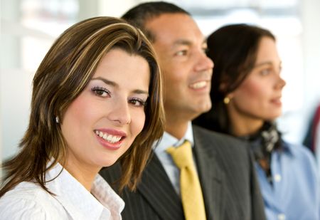 business people in an office smiling - small team