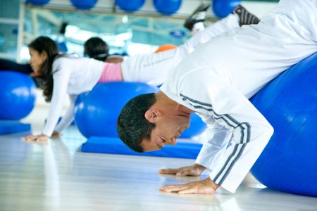 group of people doing pilates in a gym